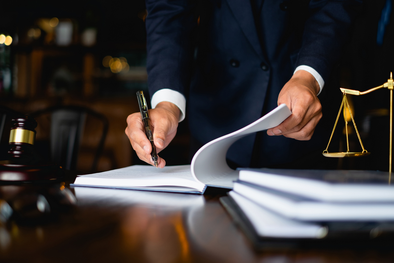 Close up lawyer businessman working or reading lawbook in office workplace for consultant lawyer concept. 5 Essential Tips On Your Path To Becoming A Lawyer